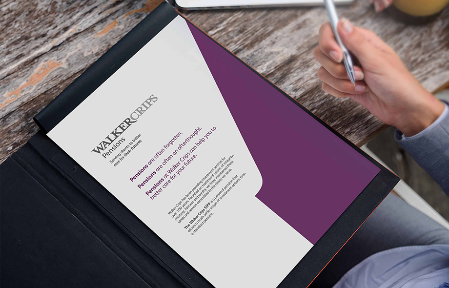 Close-up of someone reading a Walker Crips Financial Planning brochure